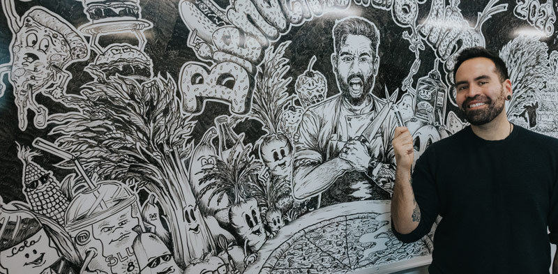 Andres Araneda with a hand-drawn mural in his classroom at École Wascana Plains School in Regina.